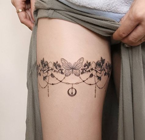 30 Lovely Thigh Tattoos To Enhance Your Feminity Thighs Tattoo Women, Thigh Line Tattoos, Tattoos Thighs, Thigh Jewelry Tattoo, Upper Thigh Wrap Around Tattoo, Garter Tattoos For Women, Tattoo Ideas On Thigh, Dark Thigh Tattoo, Ladies Thigh Tattoo Ideas