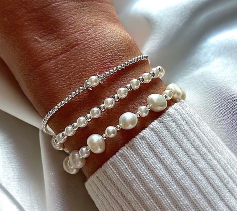 This Mother’s Day, treat your queens to the queen of all gemstones! Pearls are a unique symbol of strength, wisdom and unconditional love just like our mums 😍 Honor the significant women in your life this Mother’s Day with a gift of pearls. These timeless and elegant gems are a thoughtful gesture to express your gratitude and affection. Their classic design allows them to be worn on any occasion, making them a versatile and heartfelt present. Treat them to our most loved freshwater Pearl ... Bracelet Stack Ideas Silver, Pearl Bracelet Stack, Stacked Beaded Bracelets, Silver Bridal Jewellery, Silver Pearl Bracelet, Bracelets Design, Diy Bracelet Designs, Jewellery Gifts, Freshwater Pearl Bracelet