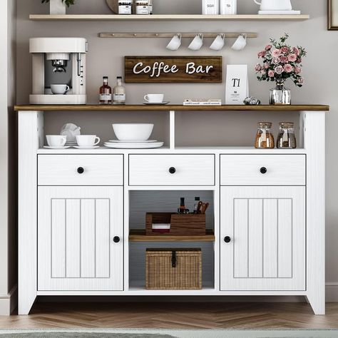 PRICES MAY VARY. AMPLE SPACE WITH 3 DRAWERS 2 OPEN SHELF: This upgraded coffee bar cabinet adds 3 drawers and 2 open shelves to other coffee bar cabinet on the market, allowing for versatile storage while still displaying your items. CLASSIC FARMHOUSE STYLE DESIGN: Classic cottage design: pure white with wood grain all over with a walnut top for a perfect cottage blend, combined with a variety of storage and display coffee bar configurations that are sure to shine in your home. NOT JUST A COFFEE White Buffet Cabinet, Modern Farmhouse Buffet, Farmhouse Buffet Cabinet, Coffee Bar Cabinet, Coffee Bar Station, Farmhouse Buffet, White Buffet, Farmhouse Coffee Bar, Coffee Bars In Kitchen