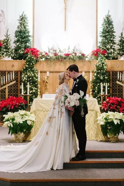 Couple sharing kiss in church surrounded by poinsettias - See More Gorgeous Winter Wedding Flower Ideas on The Knot! Christmas Wedding Flowers, Burgundy Wedding Theme, Wedding Church Decor, Wedding Floral Arrangements, Indoor Wedding Receptions, Church Wedding Decorations, Wedding Themes Winter, Winter Wedding Flowers, December Wedding