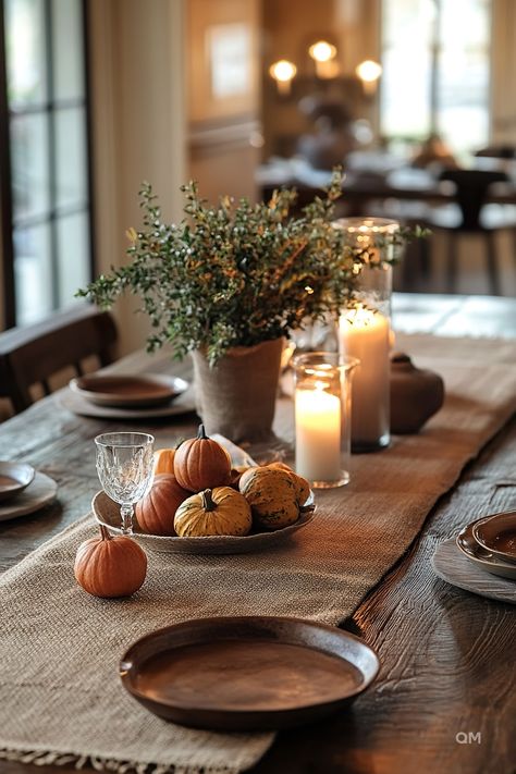 A rustic coffee table decorated for fall with small pumpkins, a green foliage centerpiece, candles, and a burlap table runner. Perfect fall coffee table decor. Simple Centerpiece Thanksgiving, Mini Pumpkin Tablescape, Pumpkin Tablescape Fall Decorating, Fall Decor Leaves, Thanksgiving Decorations Minimalist, Simple Everyday Table Centerpieces, Simple Fall Arrangements, Thanksgiving Decorations Simple, November House Decor