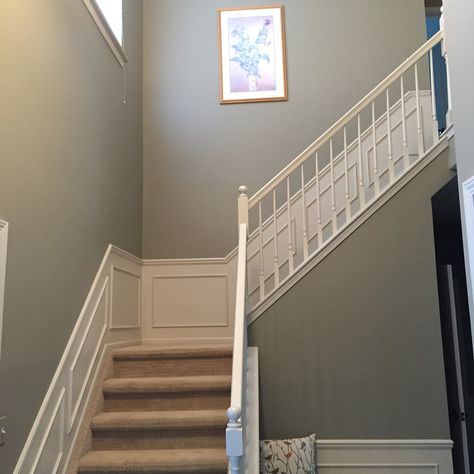 Benjamin Moore River Reflections updates a sage green foyer. Sage Green Panelling Hallway, Sage Green And White Hallway, Sage Green Stairs And Landing, Sage Green Foyer, Sage Green Staircase, Sage Green Stairs, Sage Green Hallway And Stairs, Sage Hallway Ideas, River Reflections Benjamin Moore