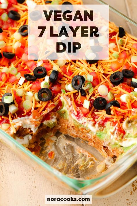 This incredible Vegan 7 Layer Dip has layers of refried beans, guacamole, sour cream, cheese, and more in every bite! It’s a perfect party dip to serve with tortilla chips at game days, family gatherings, and potlucks. | vegan 7 layer dip recipe | vegan 7 layer bean dip recipe | vegan 7 layer dip easy | 7 layer taco dip vegan 7 Layer Dip Recipe, Dairy Free Dips, Dairy Free Appetizers, Layered Bean Dip, 7 Layer Dip, Layered Taco Dip, Vegan Dips, Tortilla Chip, Dairy Free Treats