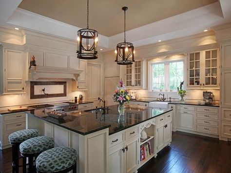 The white cabinets here are definitely elegant and when paired with the Uba Tuba granite they look even more so. The contrast of dark with light creates an eye-catching display from every angle. Ivory Kitchen Cabinets With Black Countertops, White Cabinets With Darker Countertops, Dark Granite Kitchen, Cream Colored Kitchen Cabinets, Uba Tuba Granite, Wyoming House, Affordable Kitchen Cabinets, Cream Kitchen Cabinets, Traditional Photography