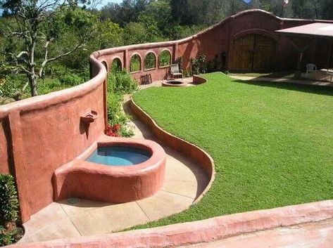 This is such a cool idea! Adding a "fence" around your home with windows. Love the fountain too, and the gate Plaster Projects, Earthbag House, Rain Water Collection Diy, Earth Ship, Cob Building, Greenhouse Design, Sustainable House, Earth Bag Homes, Intentional Community