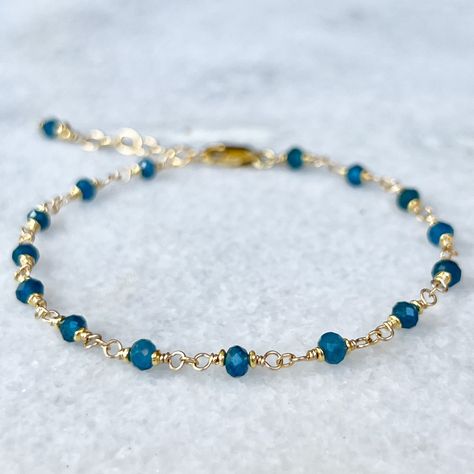 Blue apatite gemstone bracelet, hand-wrapped rosary style on 14k gold filled wire with tiny 22k gold vermeil  accent beads (gold plating over sterling silver).   Details~ *  All findings used are 14k gold filled, made to last for years to come.  * Length: Bracelets are finished with an extender chain, making them adjustable in length. I offer two size options: Sm. 6 1/2 - 7 1/2 inches or Med. 7 1/2 - 8 1/2 inches * Packaging: Your order will arrive packaged in a gift box, wrapped with a ribbon and ready for gifting. * Please visit my Etsy shop for a full selection of my handmade jewelry: https://www.etsy.com/shop/beadedgemsbycristina * Thanks so much for stopping by my shop and please let me know if you have any other questions, I am here and happy to help! Blue Gemstone Bracelet, Beads Bracelet Design, Handmade Jewelry Tutorials, Gold And Blue, Handmade Beaded Jewelry, Handmade Wire Jewelry, Blue Apatite, Beaded Bracelets Diy, Fashion Jewelry Earrings