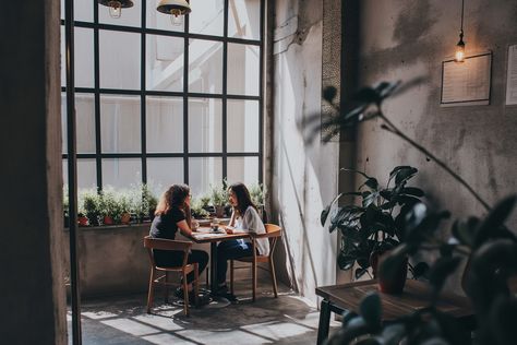 Lummi Photo - Sunlit Cafe Conversation Cafe Conversation, Small Wooden Table, Black Frames, Wooden Table, Large Windows, Wooden Tables, The Stage, Interior Spaces, Indoor Plants