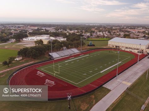 AERIAL SHOT OF A HIGH SCHOOL TRACK AND FOOTBALL FIELD IN TEXAS AT SUNRISE School Football Field, High School Football Field, School Track Field, High School Football Stadium, Football Stadium High School, High School Baseball Field, School Building Plans, High School Track, Private School Football Field