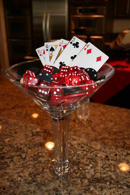 martini glass decor, bacon wrapped food, roulette shot glasses, red carnation topiary, bathroom signs, cards on glasses 40th Casino Party Casino Themed Centerpieces, Bacon Wrapped Recipes, 007 Casino Royale, Casino Birthday, Casino Night Fundraiser, Casino Party Foods, Casino Party Decorations, Casino Table, Poker Party