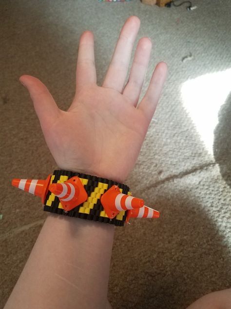 caution tape and traffic cone rotating kandi cuff made with perler beads and toy traffic cones Tape B Perler, Kandi Kid Outfit, Kandi Heart, Kandi Cuff Ideas, Rotating Kandi Cuff, Scene Kandi, Kandi Cuff Patterns, Pony Bead Projects, Kandi Inspo