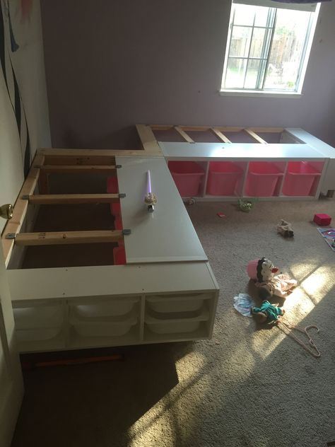 This week I finished a custom corner bed frame for my two daughters who share a room. (I still have to build the corner nightstand part) I was inspired by the Pottery Barn Corner-Bed-Frame in the picture below.   What you will need for this project: 2 IKEA Kallax Shelving… Twin Beds In Corner Of Room, Diy L Shaped Twin Beds, Kallax Twin Bed Hack, L Shaped Twin Beds Ideas Diy, L Shape Beds Twin Kids Rooms, L Shaped Beds Twin Shared Bedrooms, Corner Twin Beds Diy, L Shaped Twin Beds Ideas, Small Twin Room