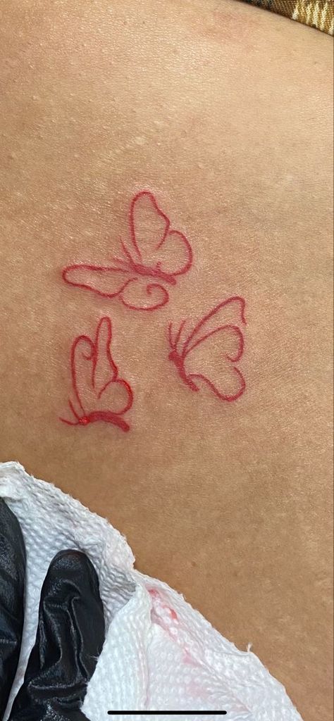 Small Red Tattoos Black Women, Tattoo Ideas Red Butterfly, Red And Black Small Tattoo, Red Butterfly Tattoo Shoulder, Red Ink Tattoos Ribcage, Secret Places To Get Tattoos, Simple Red Butterfly Tattoo, Mini Red Tattoos For Women, Red Foot Tattoos For Women