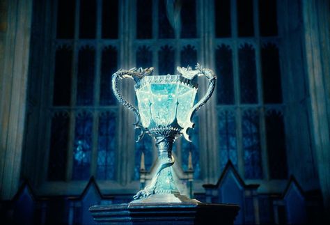 Triwizard Trophy - The Cup was made not later than 1294, date when the earliest known Triwizard Tournament took place. Ever since its creation, the Cup has been held by the victorious school until the next Tournament took place. Harry Potter Goblet Of Fire, Harry Potter Goblet, Triwizard Tournament, Goblet Of Fire, Harry Potter, Glass, Silver, Blue