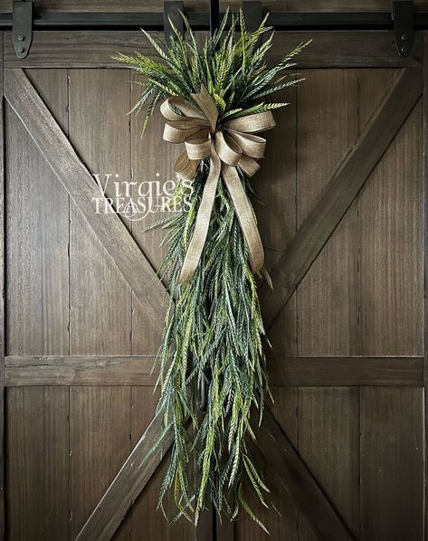 "Add a touch of color and fullness to your door with this Saw Grass Swag. This swag features luscious, soft, plastic greenery. Finished with a faux burlap bow. Length: 43\" Width: 9\" Loop on the back to hang.  Add it to a wall or door in your living room, bedroom, or kitchen! Dress up your door anywhere in your home with this beautiful everyday wreath.  Visit www.facebook.com/virgiestreasures to see many more! Don't forget to like us on Facebook! All sales are final.  See shop policies." Spring Door Swag, Pampas Grass Swag, Fall Swags For Front Door, Christmas Swags Ideas, Modern Wreaths, Greenery Swag, Spring Swag, Front Door Swag, Door Swags