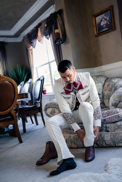 Groom almost ready #weddingparty #wedding #groom #charro #suit #mens #suit #white #burgundy #pattern #design #traditional #mexican Charro Wedding Ideas, Mariachi Wedding, Mariachi Outfit, Traditional Mexican Wedding, Mariachi Suit, Hispanic Wedding, Charro Wedding, Charro Outfit, Charro Suit