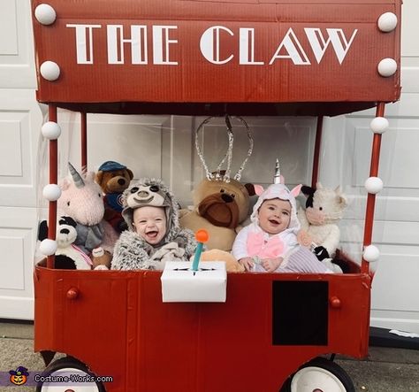 Claw Game Costume, Pumpkin Patch Stroller Costume, Claw Machine Costume Wagon, Twins First Halloween Costumes, The Claw Halloween Costume, Family Costumes With Wagon, Claw Machine Halloween Costume, Wagon Costumes For Babies, Family Halloween Costumes With Wagon