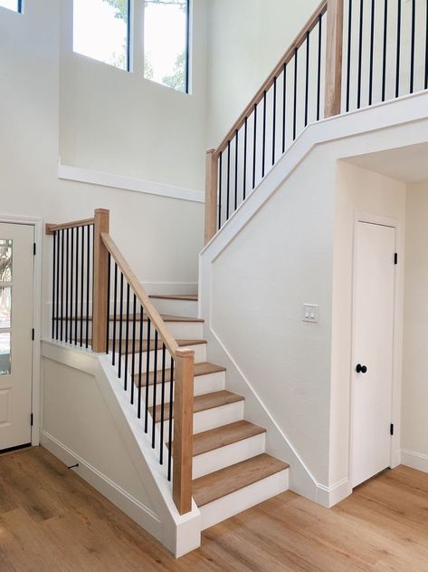 Wood Stairs Iron Railing, White And Wood Stair Railing, Dark Railing Light Floor, Add Railing To Stairs, Farmhouse Spindles Stairs, Oak Spindle Staircase, Rambler Staircase, Closed Tread Staircase, Wood And White Stair Railing