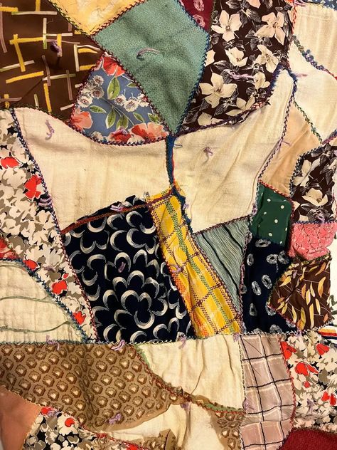 Close up of another vintage crazy quilt made from silks; Crazy quilts have asymmetrical designs, vibrant colors, and intricate stitching patterns. Originating in the late 19th century as a rebellion against the rigid rules of traditional quilting, this unique art form allows quilters to unleash their imagination and showcase their individuality through a patchwork of fabrics. How To Sew A Crazy Quilt, Vintage Crazy Quilts, Crazy Quilt Patterns Free, Crazy Quilt Ideas, How To Make A Crazy Quilt, Scrappy Patchwork Quilts, Crazy Quilts For Beginners, Scrap Quilts Ideas, Crazy Quilt Patterns