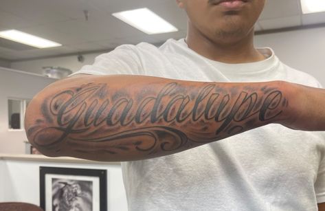 Tattoo Lettering Fonts Names, Cursive Forearm Tattoo Men, Name In Cursive Tattoo, Mom Name Tattoo For Men Forearm, Mothers Name Tattoo Ideas For Men, Last Name Tattoos For Men On Forearm, Forearm Name Tattoo Men, Moms Name Tattoo Ideas Men, Name Tattoos For Men Forearm