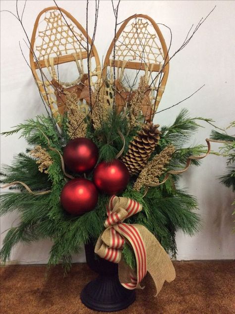 Snowshoes in Decor ~ White Arrows Home Urns Decorated For Christmas, Snowshoe Decor Christmas, Snowshoes Decor Christmas, Snowshoe Decor, Winter Urns, Christmas Urns, Outdoor Christmas Planters, Christmas Planters, Christmas Porch Decor