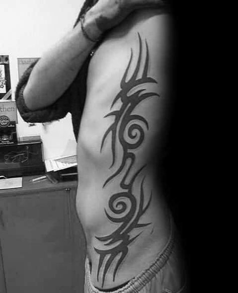 Top 40 Best Tribal Rib Tattoos For Men - Manly Ink Design Ideas Tattoo Trends 2023, Mens Side Tattoos, Trible Tattoos, Griffin Tattoo, Rib Tattoos For Guys, Tattoos On Side Ribs, Unique Tattoos For Men, Behind Ear Tattoos, See Tattoo