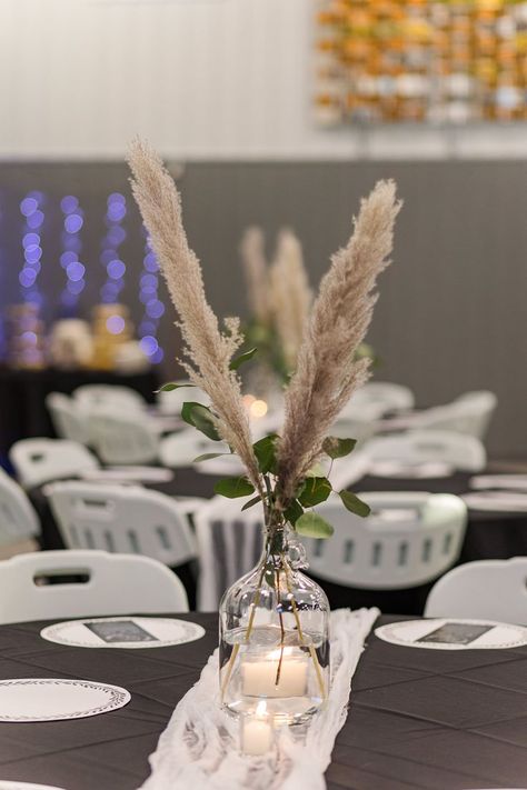 Simple and easy wedding reception centerpieces! Fake pampas grass from Hobby Lobby and live eucalyptus from local florist. Plain cheesecloth as runners and tealights on the sides. Jugs from Amazon. #centerpiece #wedding #pampasgrass #eucalyptus #cheap #easy Pampas Grass Eucalyptus Wedding, Eucalyptus Wedding Centerpieces, Eucalyptus Wedding Centerpiece, Eucalyptus Centerpiece, Wedding Reception Centerpieces, Eucalyptus Wedding, Glass Jug, Local Florist, Glass Water Bottle