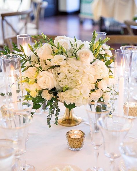 A white on white wedding with pops of green and gold will always be timeless and elegant. Las Vegas Wedding Planner @andreaeppolito Photo @stephensalazar Flowers @naakitifloral Short Wedding Centerpieces Elegant, White And Green Centerpieces, White Candles Centerpiece, Wedding Ceremony Floral Arch, White Floral Centerpieces, Pink Green Wedding, Rustic Glam Wedding, 50th Wedding Anniversary Party, Green Centerpieces