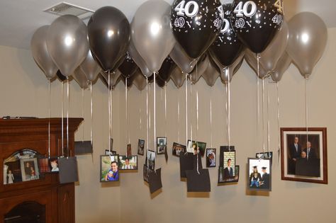 For my husband's 40th birthday I mounted pictures from his life onto black cardstock, hole punched them, and tied them to silver strings.  Then I had the balloons filled with Helium and attached the balloons to my strings and pictures.  We put 5 or so balloons in each corner of the house downstairs (30 altogether).  Everyone loved looking at the pictures, they were great conversation starters, and they also were great decorations! Birthday Surprise Husband, 40th Party Decorations, Best Birthday Surprises, Husband 40th Birthday, 40th Birthday Balloons, 40th Birthday Men, Surprise 40th, 40th Bday Ideas, House Party Decorations