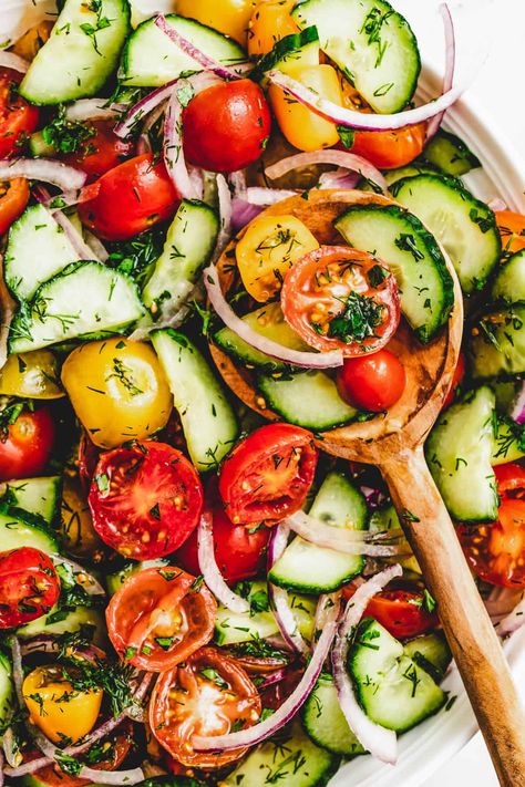 This tomato and cucumber salad is perfect for summer. Cucumber, tomatoes, and red onion are tossed together in a lemony, herb-packed dressing. It's quick and easy and it goes with just about anything. Cucumber And Tomato Recipes, Cherry Tomato Cucumber Salad, Cucumber Grape Salad, Cucumber Tomato Salad Vinegar, Tomato Cucumber Onion Salad, Tomatoe Cucumber Salad, Tomato And Cucumber Salad, Cucumber Tomato Onion Salad, Cucumber Tomato And Onion Salad