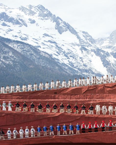 The mighty Jade Dragon Snow Mountain dominates the landscape, watching over Lijiang Old Town and Lion Hill, from which Amandayan makes its home. It also serves as the setting for Impression Lijiang, a spectacular show created by Zhang Yimou, director of the opening and closing ceremonies for the 2008 Beijing Olympics. In the open air of this vast outdoor theatre, the local Naki community perform mesmerising dances and songs from their local folklore. Outdoor Theatre, Beijing Olympics, Lijiang, Glacier Park, Outdoor Theater, Jade Dragon, Snow Mountain, The Mighty, Round Trip