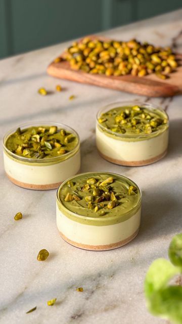 Arushi Hasija | Mills & Buns on Instagram: "These no bake pistachio cheesecake cups are so velvety smooth and creamy, you cannot stop at one 😍  The best part? It comes together in 10 minutes and there’s no baking or water bath involved 🥰  For crust 6-8 crushed digestive biscuits 20g melted butter   For filling- 100g cream cheese 50g white chocolate  40g pistachio spread 30g fresh cream 60g whipping cream 30g icing sugar  Procedure- 1. Combine the crushed biscuits and butter and press into the base of three small ramekins. Refrigerate until you make the filling.  2. To make the filling, combine the pistachio spread, white chocolate and fresh cream.  3. Whisk together the cream cheese and pistachio mixture until smooth and lump free.  4. Whip the heavy whipping cream with icing sugar until No Bake Pistachio Cheesecake, Pistachio Spread, Recipes No Bake, Pistachio Cheesecake, Cheesecake Cups, Digestive Biscuits, Parmesan Crusted, Whipping Cream, Icing Sugar