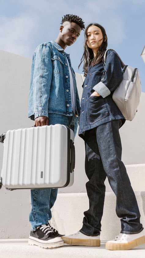 A male and female model stand with an Antler cabin suitcase in grey and an Antler Chelsea daypack in grey. Luggage Ads, Bag Campaign, Backpack Photography, Lightweight Suitcase, Lightweight Luggage, Photoshoot Studio, Portrait Photography Women, Flyer And Poster Design, Overnight Bags