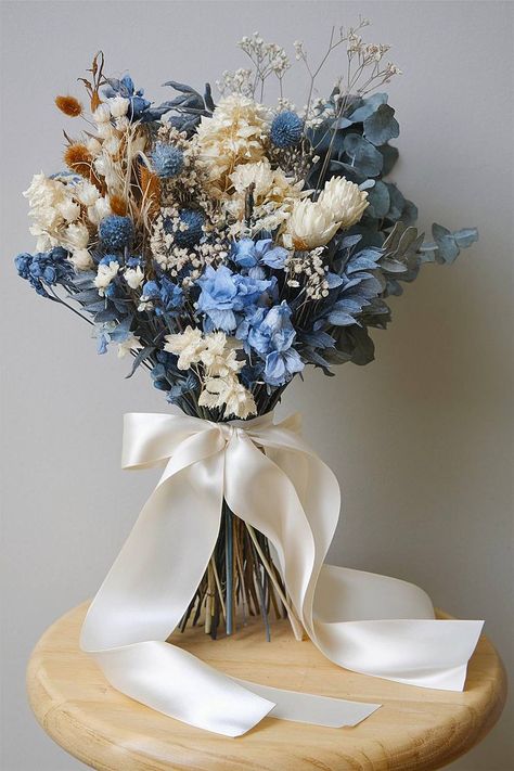 A blue and white bridal bouquet with dried and fresh flowers. Wildflower Bouquet Blue, Bride Bouquets Blue, Baby Blue Bouquet, Blue And White Bridal Bouquet, Blue And White Bouquet, Unique Bouquets, Elegant Wedding Bouquets, Unique Bouquet, Soft Modern