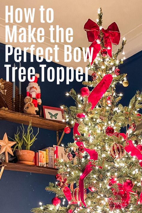 Beautifully decorated Christmas tree in red ornaments and ribbon with a beautiful bow tree topper against a blue wall Christmas Bow Tree Toppers Diy, Christmas Tree Topper Bow Tutorial, Christmas Tree Topper Tutorial, Christmas Tree Topper Bow Diy, Christmas Tree Topper Ribbon, Bow Tree Topper, Diy Tree Topper, Bow Tree, Christmas Tree Topper Bow