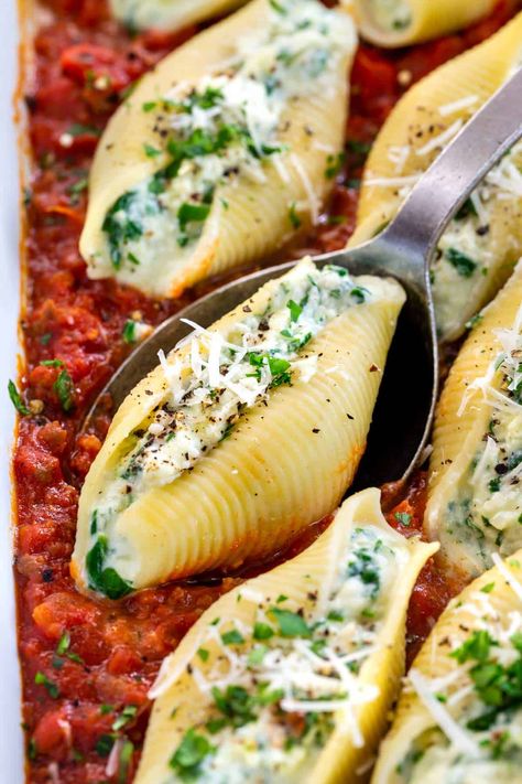 Stuffed shells recipe with spinach and three kinds of cheese! Ricotta, parmesan, and mozzarella pair nicely with a homemade sausage marinara sauce. #stuffedshells #italian #pasta Stuffed Shells With Spinach, Stuffed Shells With Meat, Seafood Stuffed Shells, Recipe With Spinach, Beef Snacks, Newfoundland Recipes, Spinach Stuffed Shells, Sausage Marinara, Stuffed Shells Ricotta