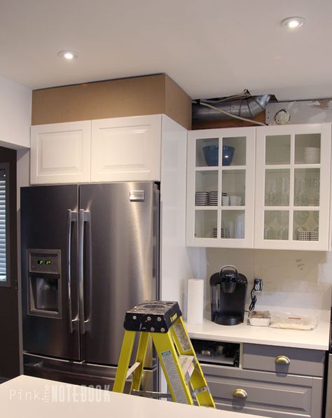 A kitchen soffit (aka bulkhead) is something that majority of us have in our kitchens. They are often created to hide wires, pipes or other mechanicals in our kitchen. Sometimes they are even there to just fill the space above your cabinets. Either way, I personally find most soffits can make a home feel dated and extremely closed-in. When it came to our kitchen renovation, we had no idea what was behind our soffits. I debated whether or not I should remove them or somehow just work with them... Removing Bulkhead In Kitchen, Camoflauge Kitchen Soffit, Kitchen With Bulkhead, Fridge Enclosure, Soffit Trim, Bulkhead Kitchen, Kitchen Soffit Decorating Ideas, Kitchen Bulkhead, Fridge Surround