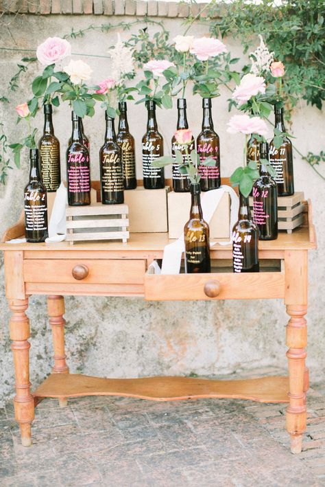 Brown Bottle Table Plan on Vintage Dresser | Photographer: Saya Photography | Wedding Venue: La Bastide du Roy | Videographer: Anh for Studio Ohlala | Wedding Dress: Rime Arodaky | Grooms Suit: Jean-Jacques Cérémonie | Accessories: Le Colonel Moutarde | Bridal Shoes: Badgley & Mischka | Catering: De Bouche en Bouche | Florist: Maud Création Florale | Hair & Makeup: Karine Brossard | Planner/Stylist: Made in You | Second Shooter: Marion for Studio Ohlala South Of France Wedding, Wine Bottle Table, Bright Wedding Flowers, Seating Plans, Wedding Wine Bottles, Rime Arodaky, Brown Bottles, Wedding Bottles, Wedding Table Plan