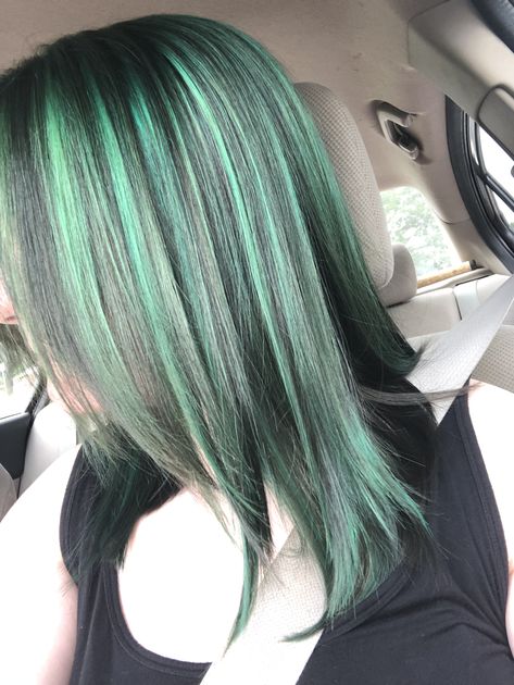 Green and black highlighted fine medium-length hair Mint Green Highlights In Black Hair, Skunk Hair Dye Green, White Hair With Green Highlights, Mint Green Highlights In Brown Hair, Green Hair Highlights For Black Hair, Blue Hair Green Highlights, Black Hair With Dark Green Highlights, Black Hair Green Streaks, Green Hair With Black Highlights