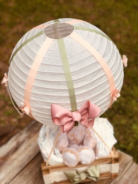 "PLEASE NOTE Item CANNOT be hung Elevate your special celebration with our enchanting Hot Air Balloon Centerpiece! Handcrafted with intricate details, this captivating decoration is perfect for travel-themed baby showers and makes a unique baby gift that will wow your guests and enhance your event décor. ✨Includes: One Monkey Plush Animal, One Crate 9\" x 12 ½\", One Paper Lantern 16\" Inch, Pink & Green Silk Ribbon, Pearl Streamer, Small Pink Flowers, Lace Ribbon, One Large Pink Bow, One Large Green Bow, Pamper Diapers ⭐️Features:  🎈Handcrafted hot air balloon centerpiece made from high-quality materials 🌎Perfect for baby showers and baby gifts 🌈Measures approximately 16 inches in diameter ☁️Lightweight 💥Available as a single centerpiece A Great Piece to have everybody talking about. Hot Air Balloon Diaper Cake, Air Balloon Centerpiece, Hot Air Balloon Centerpiece, Hot Air Balloon Centerpieces, Nursery Decor Pink, Diy Hot Air Balloons, Boy Baby Shower Centerpieces, Balloon Centerpiece, Balloon Basket