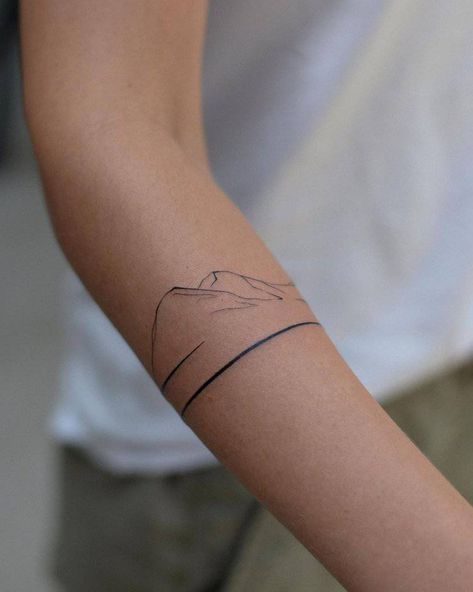 moon Arm Band Mountain Tattoo, Wrap Around The Wrist Tattoos, Mountain Tattoo Arm Band, Mountain Wrap Tattoo, Mountain Tattoo Fine Line, Mountain Arm Band Tattoo, Arm Mountain Tattoo, Mountain Minimalist Tattoo, Fineline Mountain Tattoo