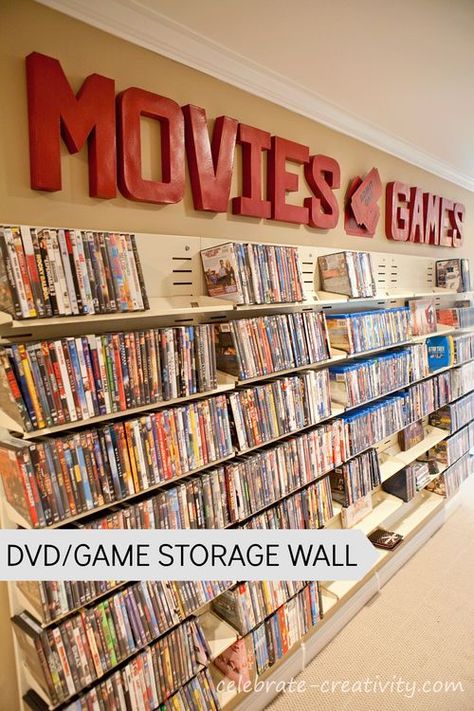 DVD/Video Game Storage Wall.  A wasted basement aisle is transformed into fun, usable space and storage. Movie Library Room, Vhs Storage Ideas, Movie Theater Themed Basement, Movie Game Office Room, Movie Theater Shelf Decor, Dvd Wall, Movie Theater Wall Decor, Vhs Storage, Movie Posters In Theater Room