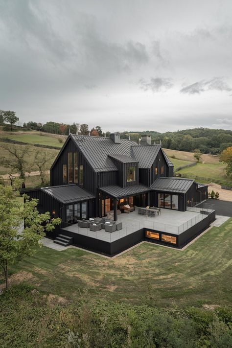 10 Black Modern Farmhouse Exteriors That Showcase Bold, Timeless Design - My Decor Inspo Modern Farmhouse Home Plans, Black Barndominium Interior Ideas, Farmhouse Barndominium Exterior, House In The Woods Exterior, Modern Barn House Exterior, Black Modern Farmhouse Exterior, Mountain Modern Home Exterior, Farmhouse With Garage, Black Barndominium Exterior