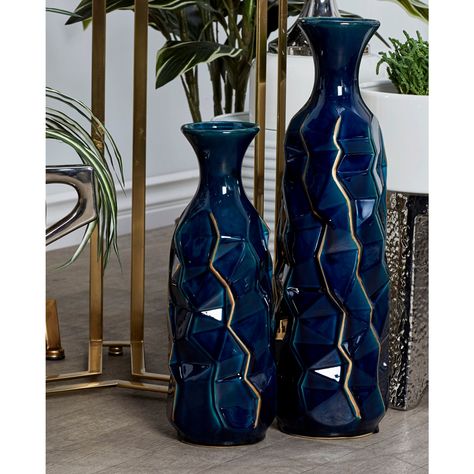 "Buy Blue Stoneware Modern Vase at Michaels. com. Add charm to your home with this unique vase. Add an innovative touch of abstract-inspired decoration into your eclectic, artistic, and modern living space with this splendidly smooth glazed denim blue vase! This rich and alluring home decor showcases a tall abstract-shaped edgy vase with a narrow neck, flannel-shaped mouth, and cracked golden line accents made of stoneware material. Its deep, denim blue tone and unique, irregular shape make it a Blue And Gold Living Room, Blue And Gold Bedroom, Navy Blue Decor, Blue Vases, Gold Living, Blue Living Room Decor, Unique Vase, Gold Living Room, Gold Bedroom