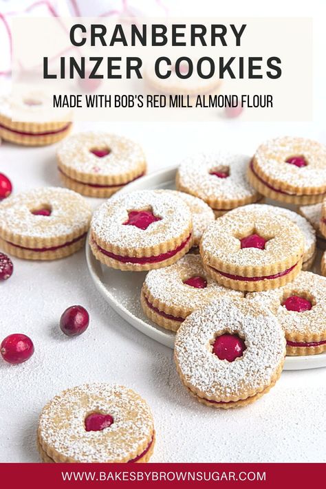 These Cranberry Linzer Cookies are a delicious combination of an almond and orange butter cookie and cranberry curd. It's one of the best linzer cookies you'll ever make and it's the perfect Christmas cookie to share with family and friends this holiday season. Get the recipe at Bakes by Brown Sugar. #bakesbybrownsugar #bobsredmill #bakedwithBobs #Christmascookies #cranberry #linzercookies #orange Cranberry Swirl Cookies, Cranberry Linzer Cookies, Cranberry Lemon Cookies, Xmas Foods, Cranberry Curd, Cranberry Orange Cookies, Orange Butter, Christmas Eats, Jelly Cookies