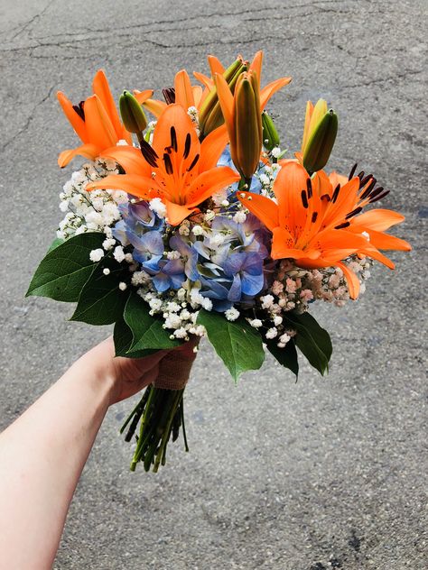 Wild flower Bridal bouquet- Tiger lilies with hydrangea, baby’s breath and a collar of lemon leaf greenery Bouquet With Tiger Lillies, Tiger Lilies Bouquet, Tiger Lily Wedding Cake, Tiger Lilly Wedding Ideas, Colorful Lily Bouquet, Day Lily Bouquet, Flower Bouquet Tropical, Tiger Lily Bridal Bouquet, Tiger Lily Flower Arrangements