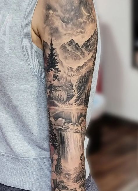 An unbelievably realistic black and grey mountain scenery sleeve tattoo, done by @katarina.heinze. Within this piece is a starry night sky with a crescent moon, trees, a waterfall, rocks, a lake, and of course the rocky peaks of the mountains. Mountain Sleeve Tattoo, Scenic Tattoo, Waterfall Tattoo, Natur Tattoo Arm, Scenery Tattoo, Lake Tattoo, Cream Tattoo, Sky Tattoos, Christian Sleeve Tattoo