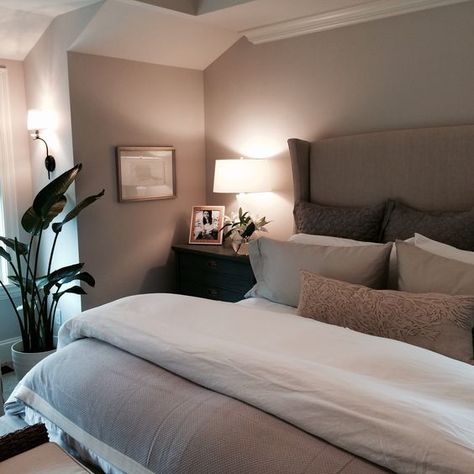 a taupe bedroom with taupe walls, an upholstered bed, dark stained nightstands and lots of lamps plus a statement potted plant Taupe Bedding, Taupe Bedroom, Taupe Walls, Redecorate Bedroom, Master Bedrooms Decor, Room Inspiration Bedroom, Room Ideas Bedroom, Aesthetic Bedroom, Home Room Design