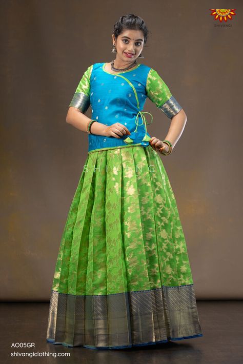 Grapevine Pattu Pavadai | Lehenga !!! Knife pleated skirt highlighted with floral jangla pattern paired with angrakha blouse. A perfect traditional yet trendy Pattupavadai for any special occasion. Click to buy : https://bit.ly/30SZvMv Whatsapp : 8098833000 #Shivangiclothing #newcollection #festiveseason #pattupavadai #ethnic #lehenga #kidsfashion #shoponline #instafashion #shopnow #diwalicollection #coimbatore #girlswear Pattu Pavadai Designs For Adults, Pattu Skirt And Blouse, Saree To Pattu Pavadai, Simple Pattu Pavadai Designs, Pattupavadai Designs For Women, Latest Pattu Pavadai Designs, Pattu Pavadai Designs Women, Pattu Langa Blouse Designs, Pattu Pavada Women