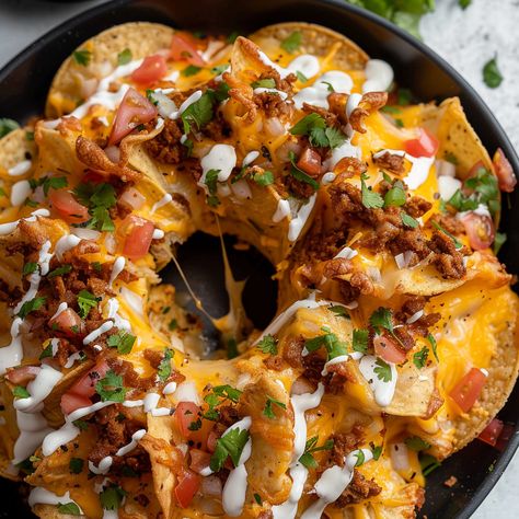 Bundt Pan Nachos are a fun and innovative twist on a classic favorite. This dish combines layers of seasoned ground beef, gooey cheese, and crispy tortilla chips, all baked together in a bundt pan for ... READ MORE Bundt Pan Meals, Nachos In Bundt Pan, Bundt Pan Nachos, Bundt Pan Recipes, Pan Nachos, Easy Nachos, Card Night, Seasoned Ground Beef, Chicken Taco Seasoning