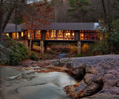 Nestled in a beautiful forested landscape with a creek running below the home in Cashiers, North Carolina, the Knob Creek Residence was designed by Platt Architecture and built by Schmitt Building Contractors. Mountain Dream Homes, Bridge House, Log Home Plans, Rustic Exterior, Billion Dollars, Building Contractors, Mountain Living, Home Landscaping, Dream Houses